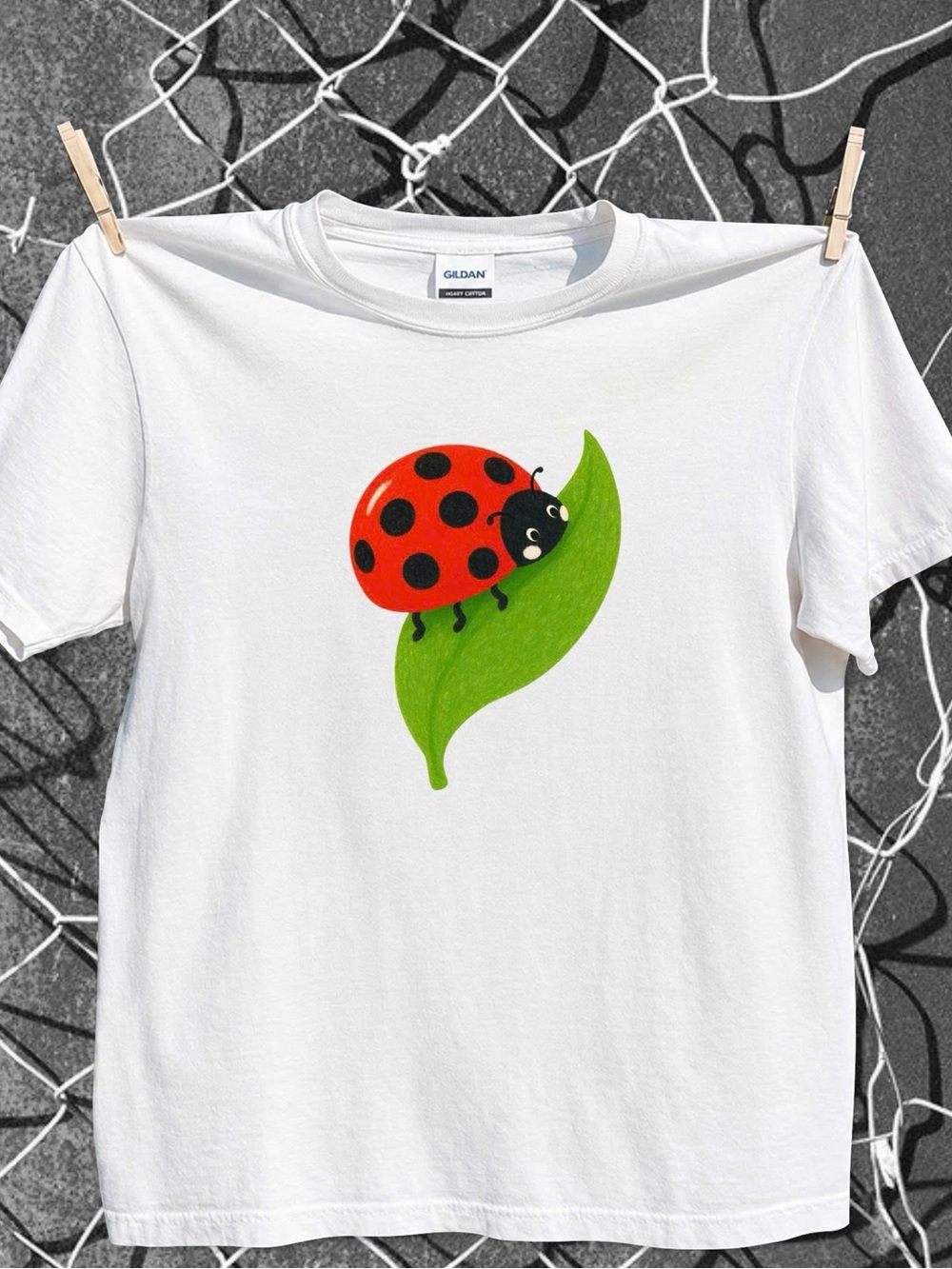 Red Ladybug on Green Leaf Gildan size L Tee
